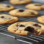 Freshly baked homemade chocolate chip cookies with gooey melted chocolate.